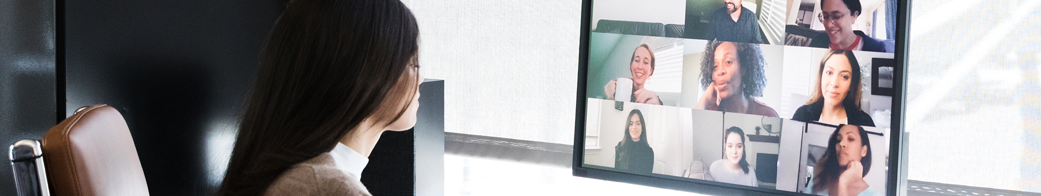 Woman at home in a virtual meeting on computer