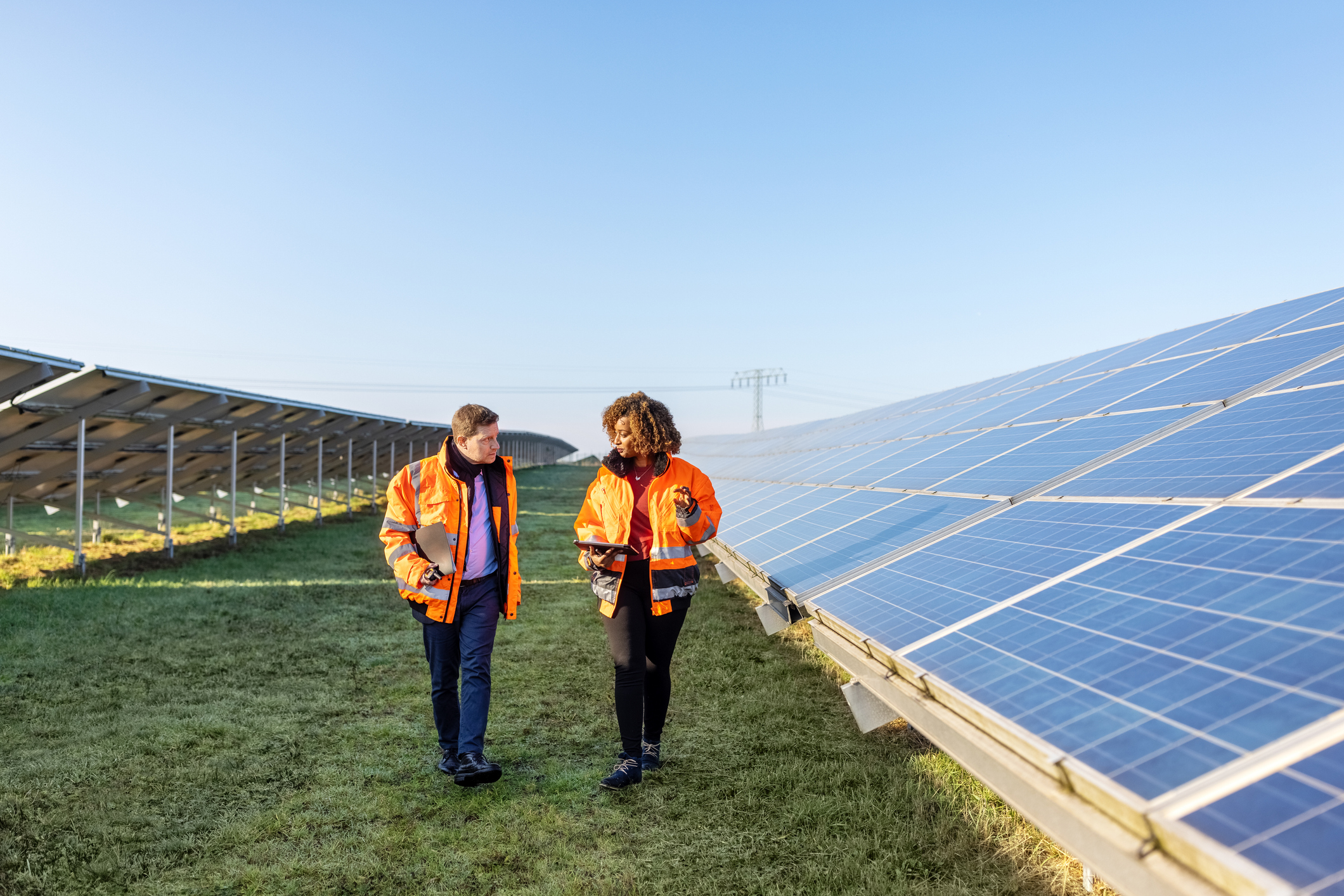 Image of two workers on a solar panel.