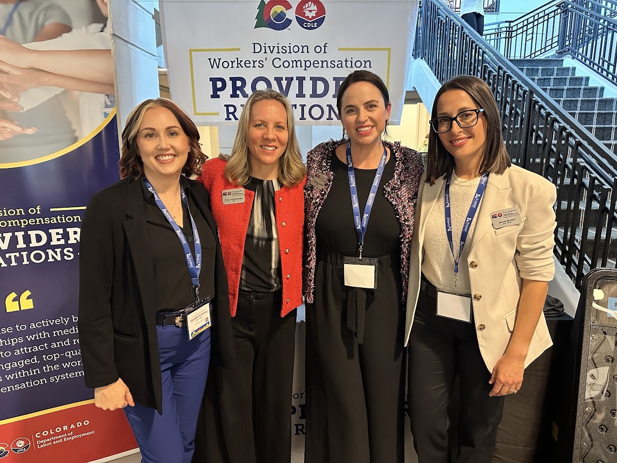 The four members of the Provider Relations team standing together and smiling at a conference